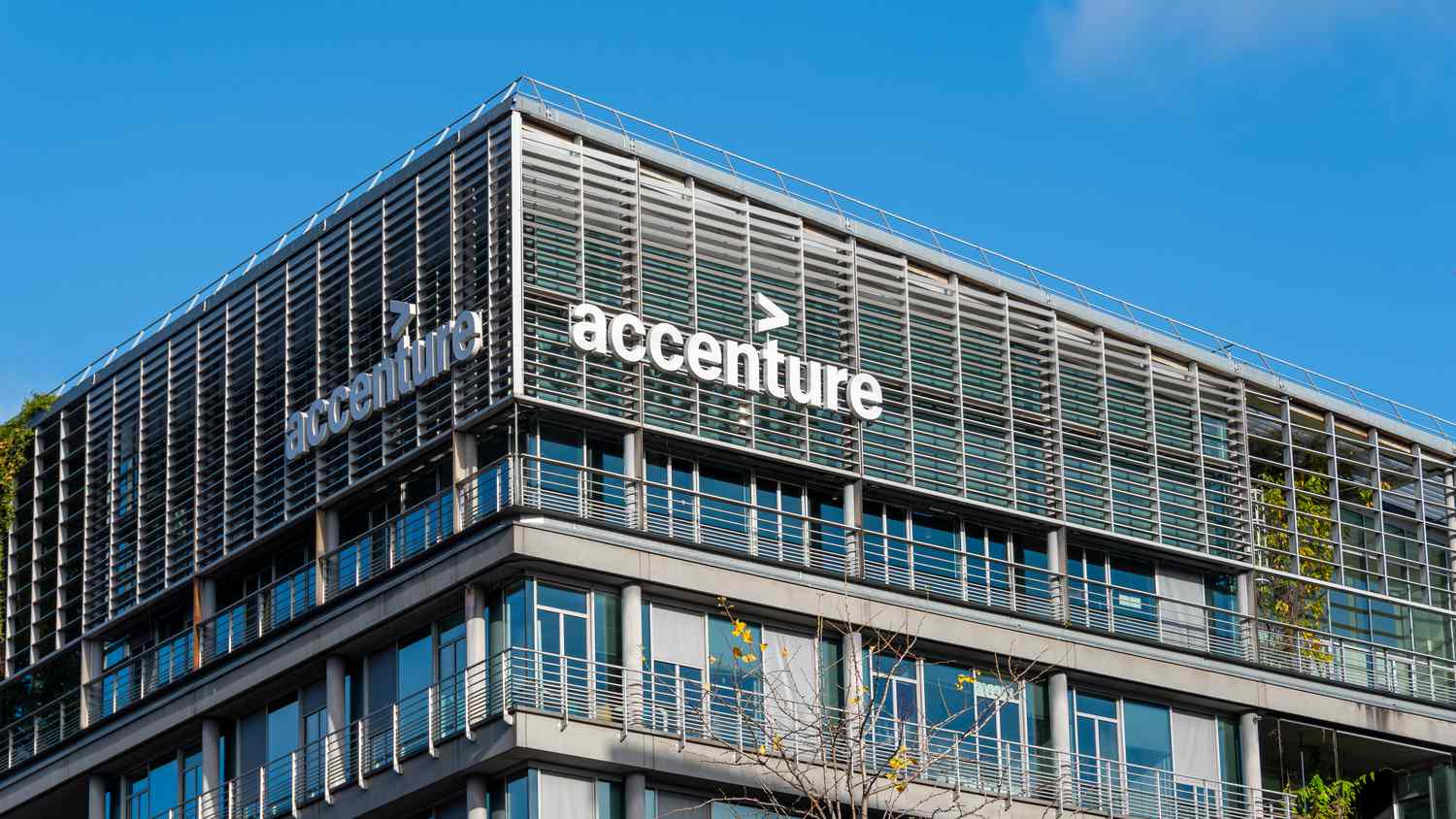 Accenture Stocks logo with a background showing semiconductor design and engineering concepts.